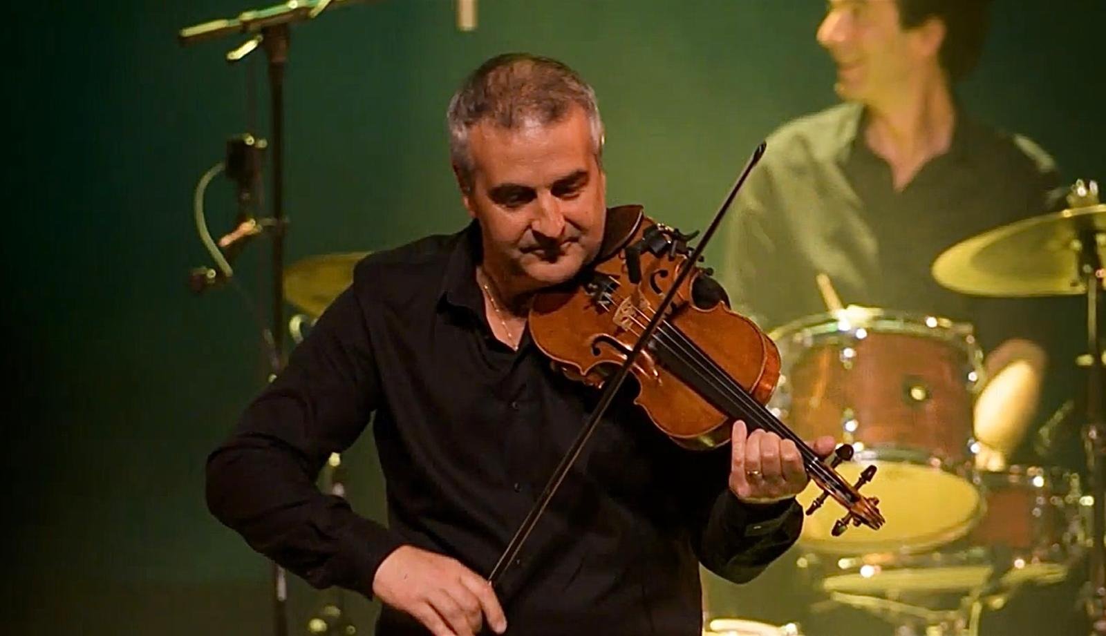 Claude Tedesco au violon sous les lumières de scène
